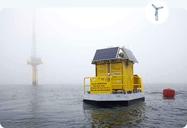 Buoy in the sea with a wind turbine icon above the photo